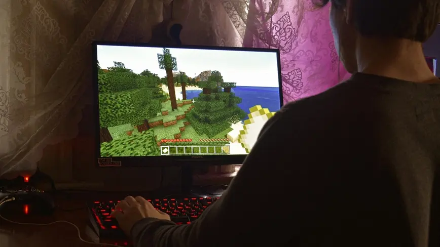 Mladý muž hraje hru na počítači